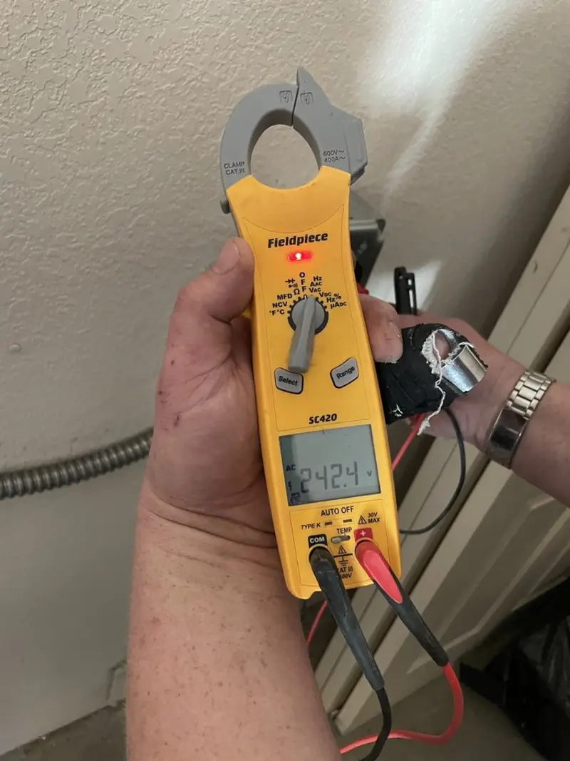 Voltage testing with clamp meter during Outlet Installation in Tampa